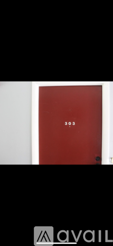 A red door with the number 303 on it.