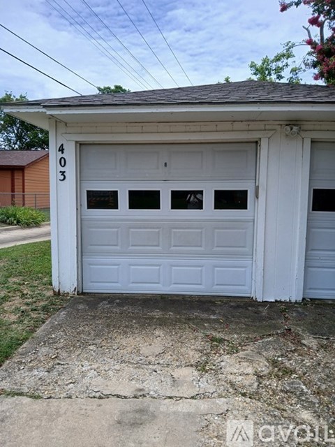A white garage door with the number 403 on it.