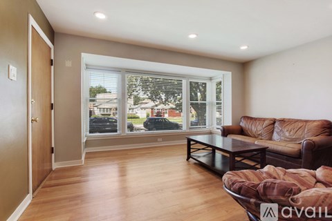 A living room with a brown couch and a coffee table.