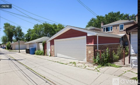 A street view of a residential area with houses and a clear sky.
