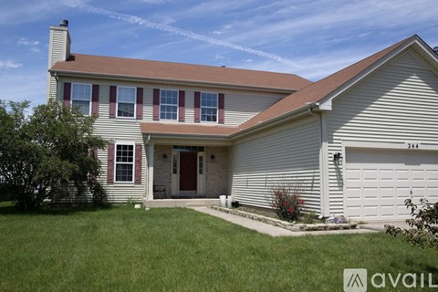 A house with a red door and a garage.