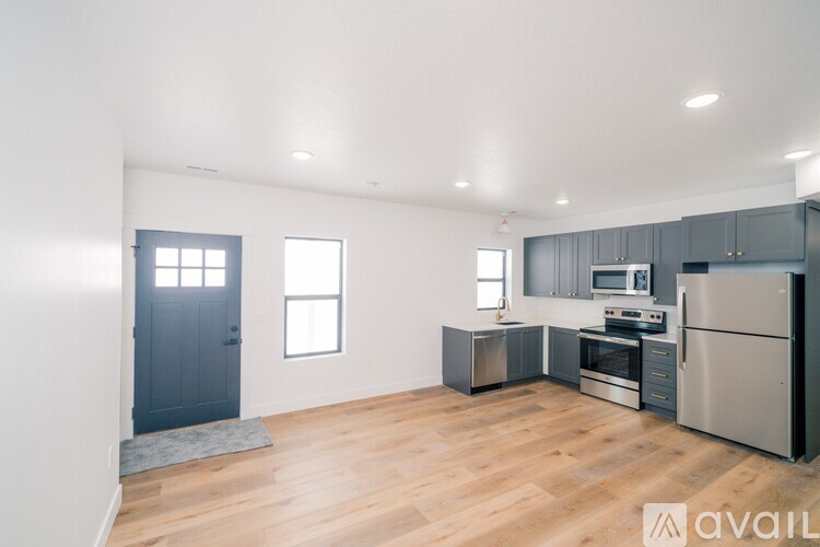 A kitchen with wooden floors and stainless steel appliances.