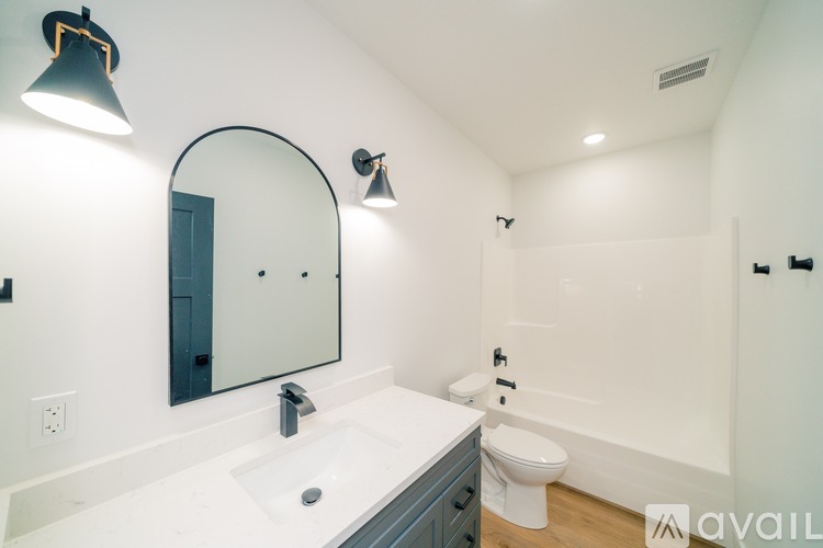 A bathroom with a white sink and a mirror.