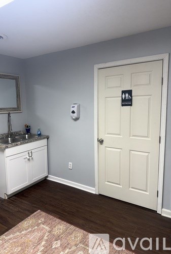 A white door with a sign on it in a room.