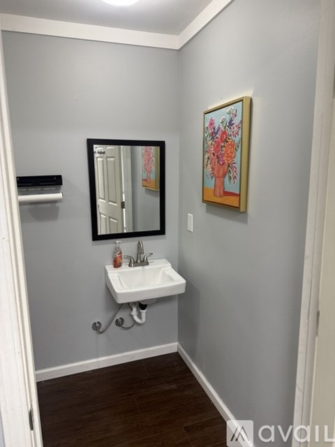 A bathroom with a sink and a mirror.