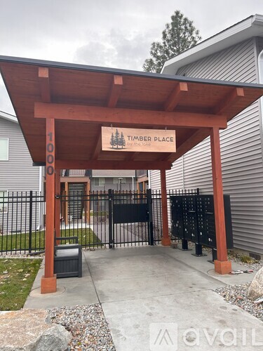 A wooden covered walkway leads to a building named Timber Place.