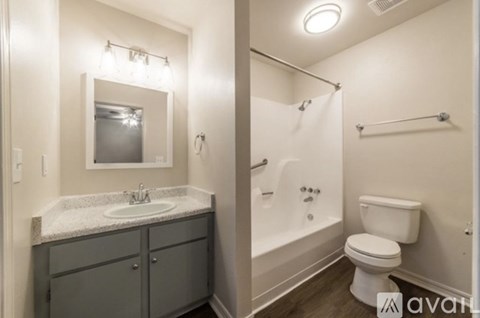 A bathroom with a sink, toilet, and bathtub.