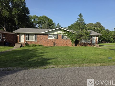 A house with a green lawn in front of it.