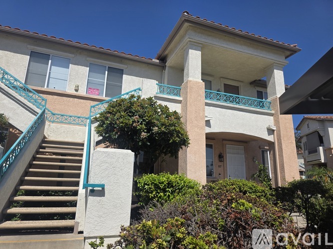A house with a staircase and a balcony.