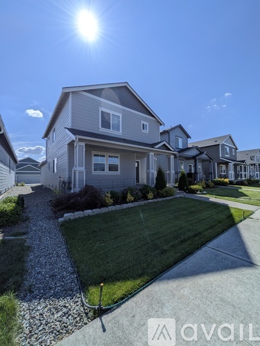 A sunny day in a residential area with houses and a clear sky.