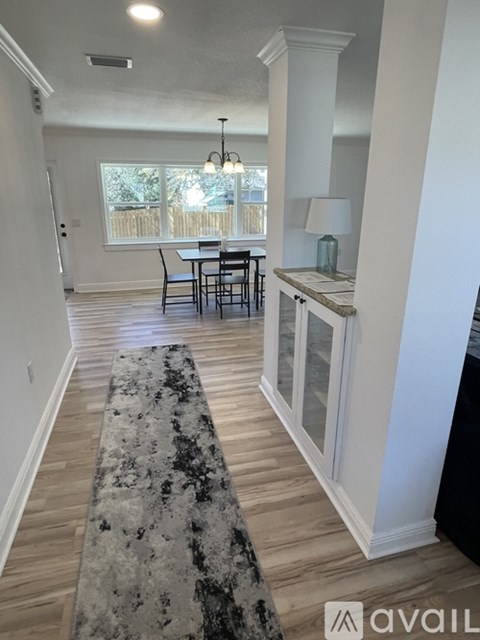 A dining room with a table and chairs is shown.