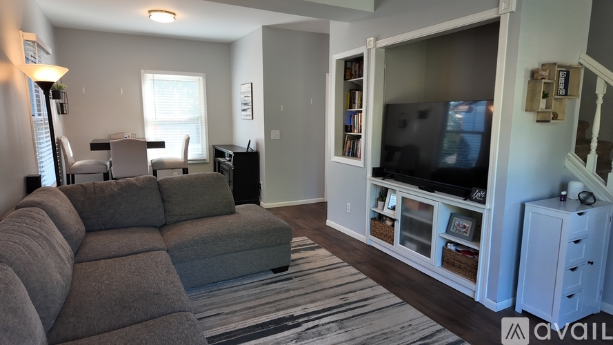 A living room with a grey couch and a television.