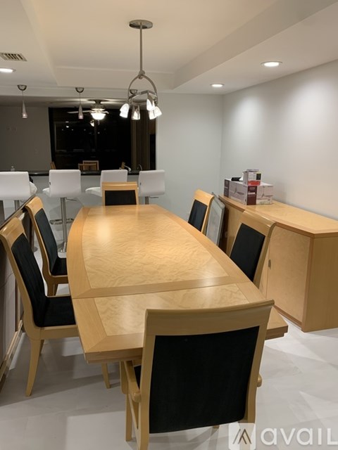A conference room with a long table and chairs.