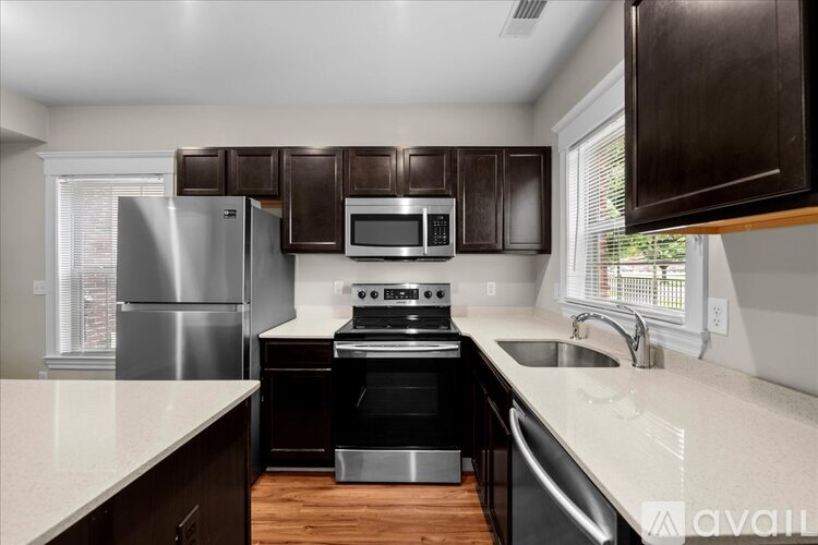 A kitchen with a stove top oven and a refrigerator.