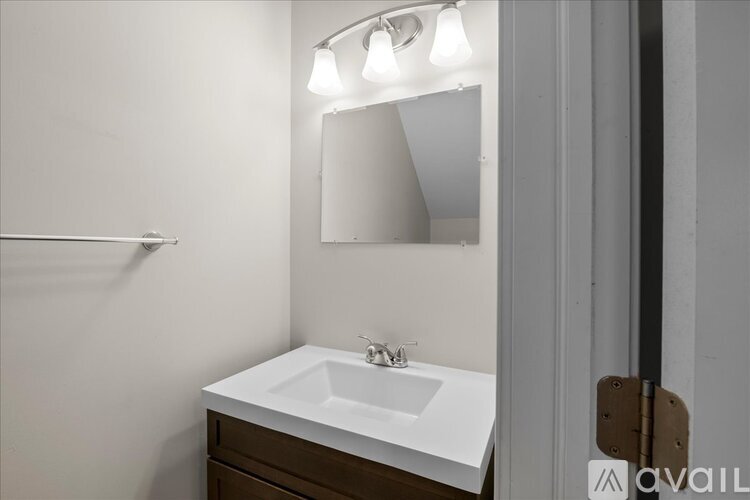 A bathroom with a sink and mirror.