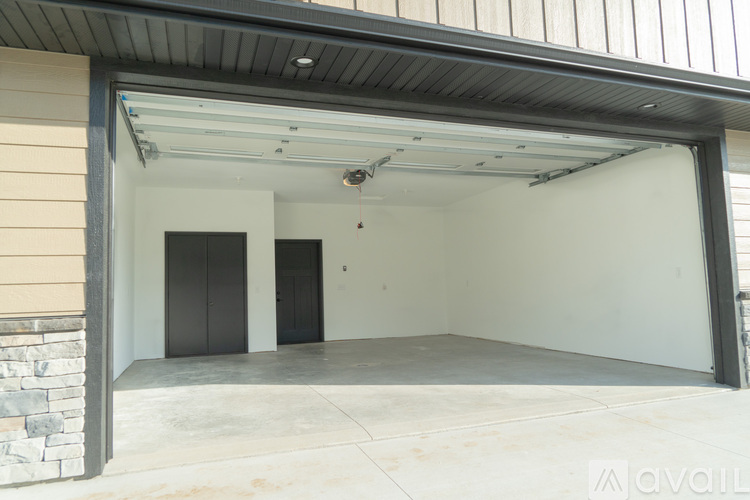 A spacious garage with a stone wall and two doors is available for rent.
