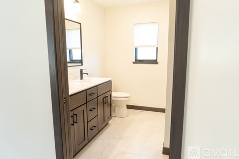 A spacious garage with a stone wall and two doors is available for rent.