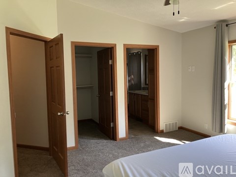 A bedroom with a bed, a dresser, and a mirror.