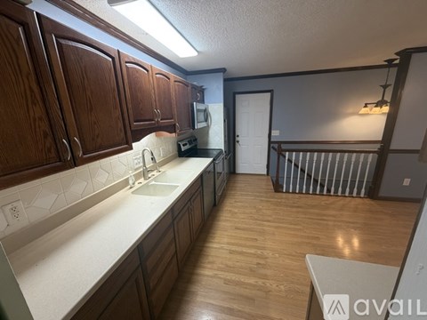 A kitchen with wooden cabinets and a countertop.