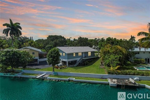 A house with a dock in front of it is available for sale.