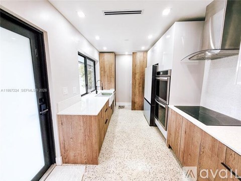 A kitchen with a black fridge and a black oven.