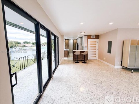 A spacious room with a view of a street outside the large window.