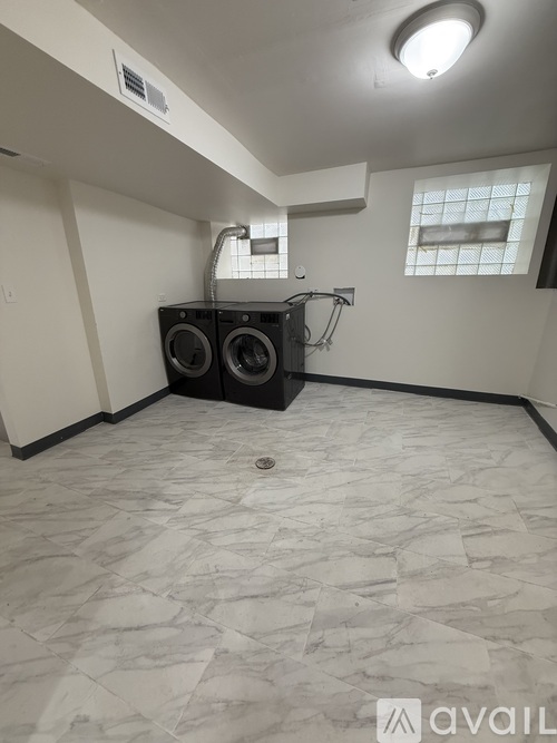 A room with a washer and dryer in it.