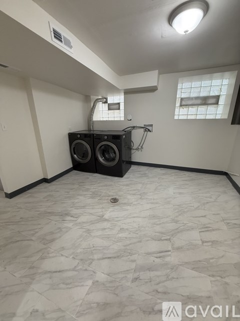 A room with a washer and dryer in it.