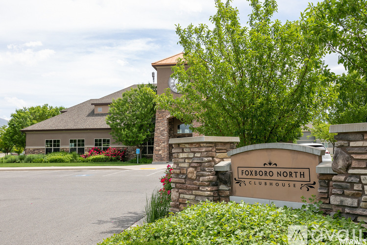 The entrance to the Foxboro North Clubhouse is surrounded by greenery.