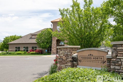 The entrance to the Foxboro North Clubhouse is surrounded by greenery.