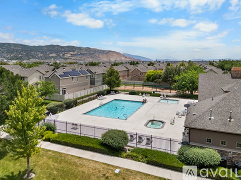 A pool surrounded by a fence and a mountain in the background.