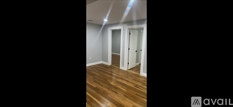 A room with wooden floors and a white door.