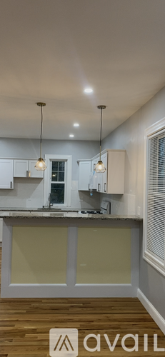 A kitchen with a counter and a window.