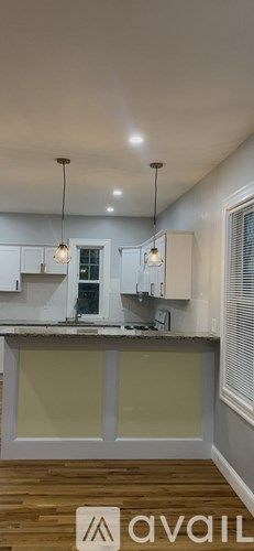 A kitchen with a counter and a window.