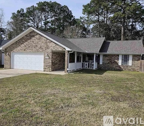 A house with a garage and a covered porch is available for sale.