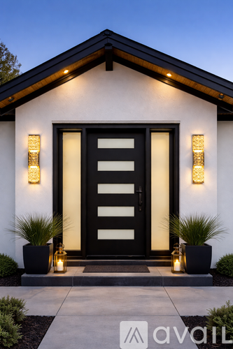 A house with a black front door and two lights on either side.