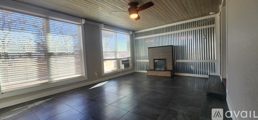 A living room with a fireplace and a television.