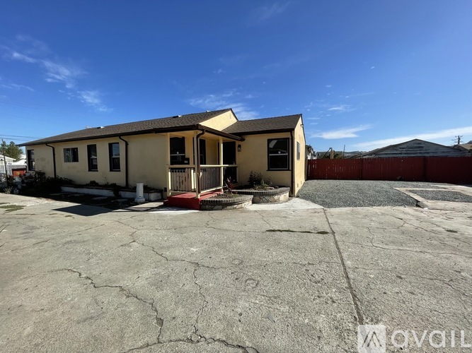 A house with a cracked ground in front of it.