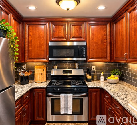 A kitchen with wooden cabinets and a black stove top oven.