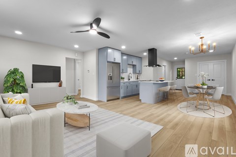 A modern living room with a white sofa, a coffee table, and a television.