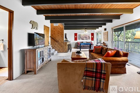 A living room with a brown chair and a wooden cabinet.