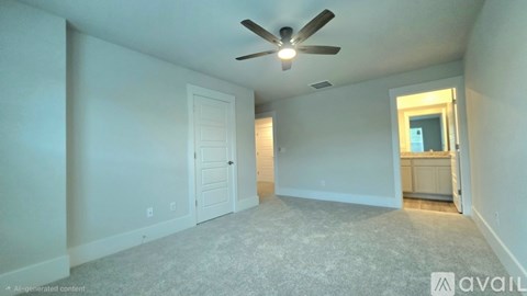 A spacious room with a ceiling fan and carpeted floor.