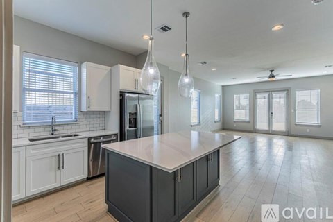 A modern kitchen with a large island in the center.