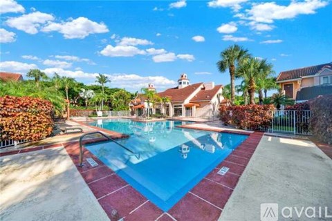 A swimming pool surrounded by a red brick border.