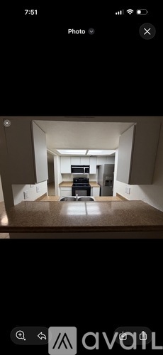 A photo of a room with a desk and a couch.