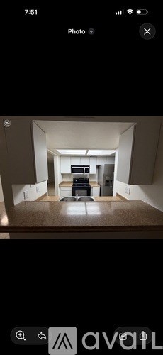A photo of a room with a desk and a couch.