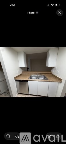 A small kitchen with a sink and cabinets.