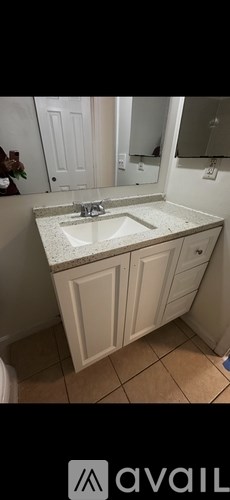A bathroom with a sink and a mirror.