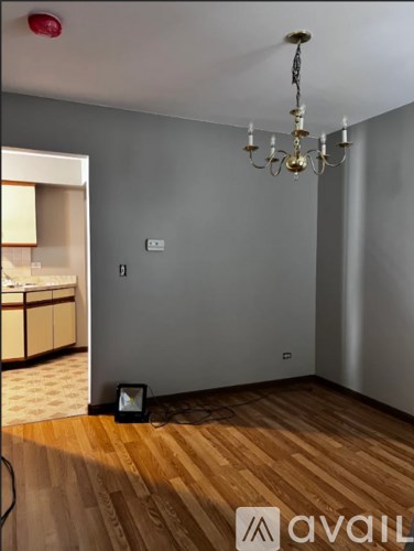 A room with wooden floors and a chandelier.