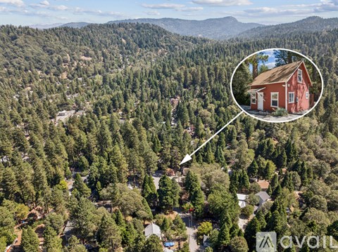 A red house is shown in a small inset image, located in a forested area.